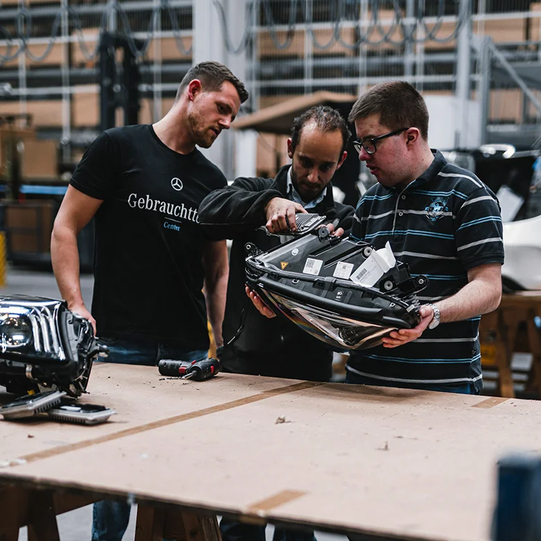 At our Neuhausen auf den Fildern plant, employees with and without disabilities work side by side on a vehicle front — a living example of inclusion and social responsibility in action. 0