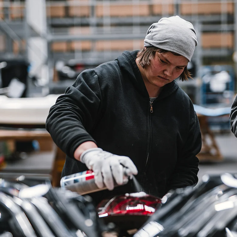 At our Neuhausen auf den Fildern plant, employees with and without disabilities work side by side on a vehicle front — a living example of inclusion and social responsibility in action. 2